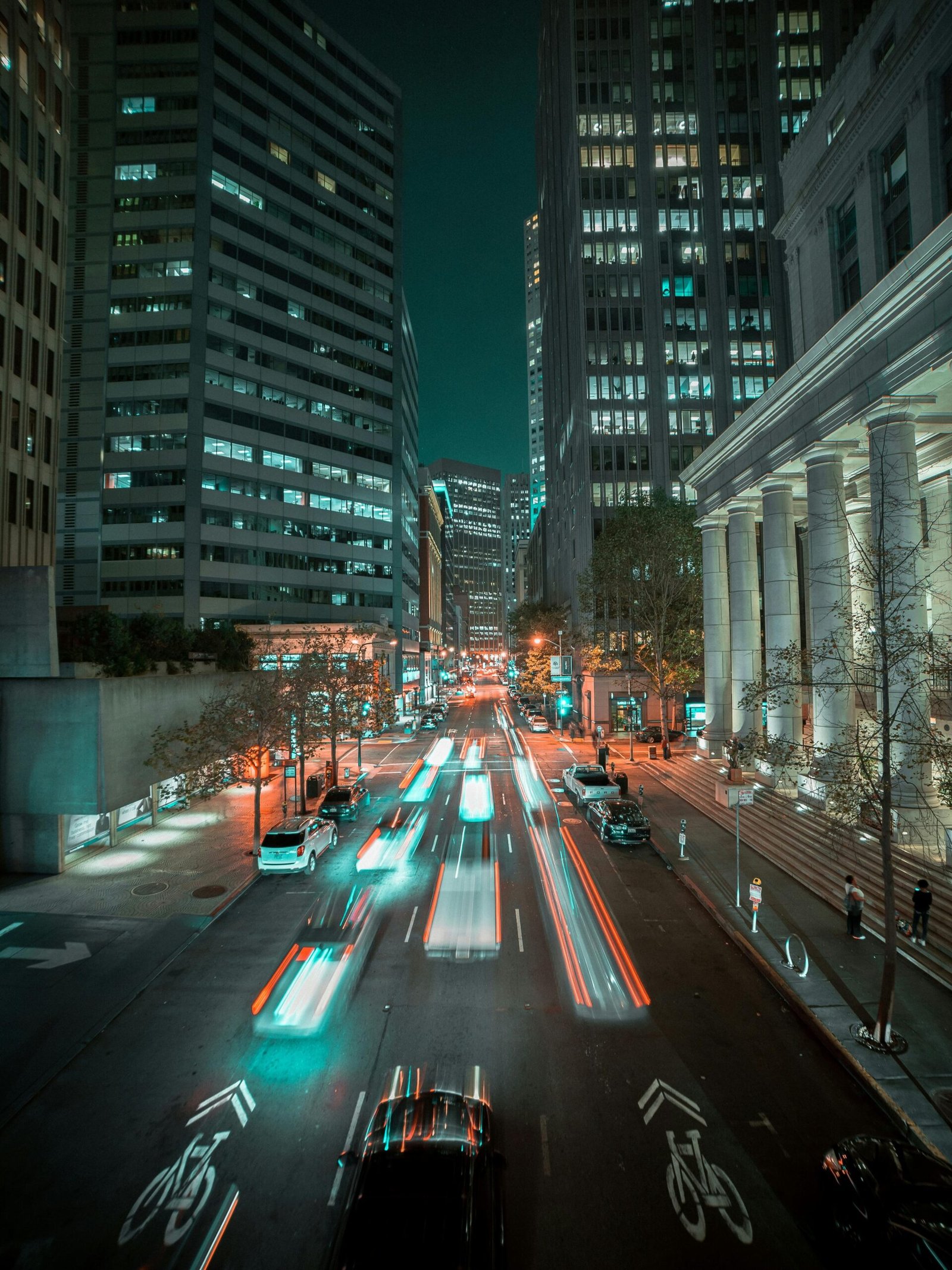 Long exposure of vibrant city traffic and skyscrapers in San Francisco at night.